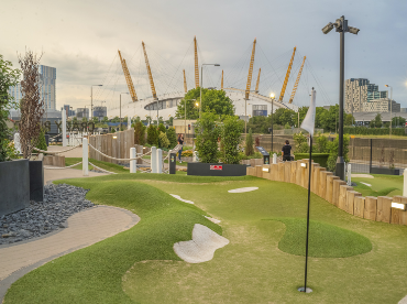 The course at Crazy Putt Advenutre Golf on Greenwich Peninsula with a view of The O2 behind.