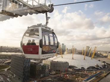 The Emirates Air Line swooping over Greenwich Peninsula and the river Thames in front of The O2.
