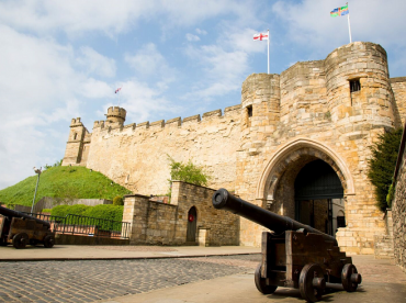 A cannon and the front entrance of Lincoln Castle
